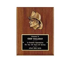 Wooden plaque with a gold firefighter head profile and an engraved plate thanking Chief Hallahan for 20 years of service, 1996.