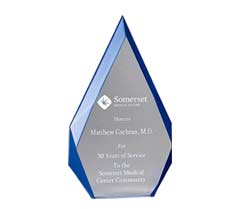 A blue-edged glass award engraved with text honoring Matthew Cochran, M.D., for 30 years of service.