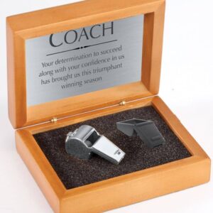 A wooden box labeled "COACH" with a message, includes metal and black plastic whistles in foam. Product: 6075.