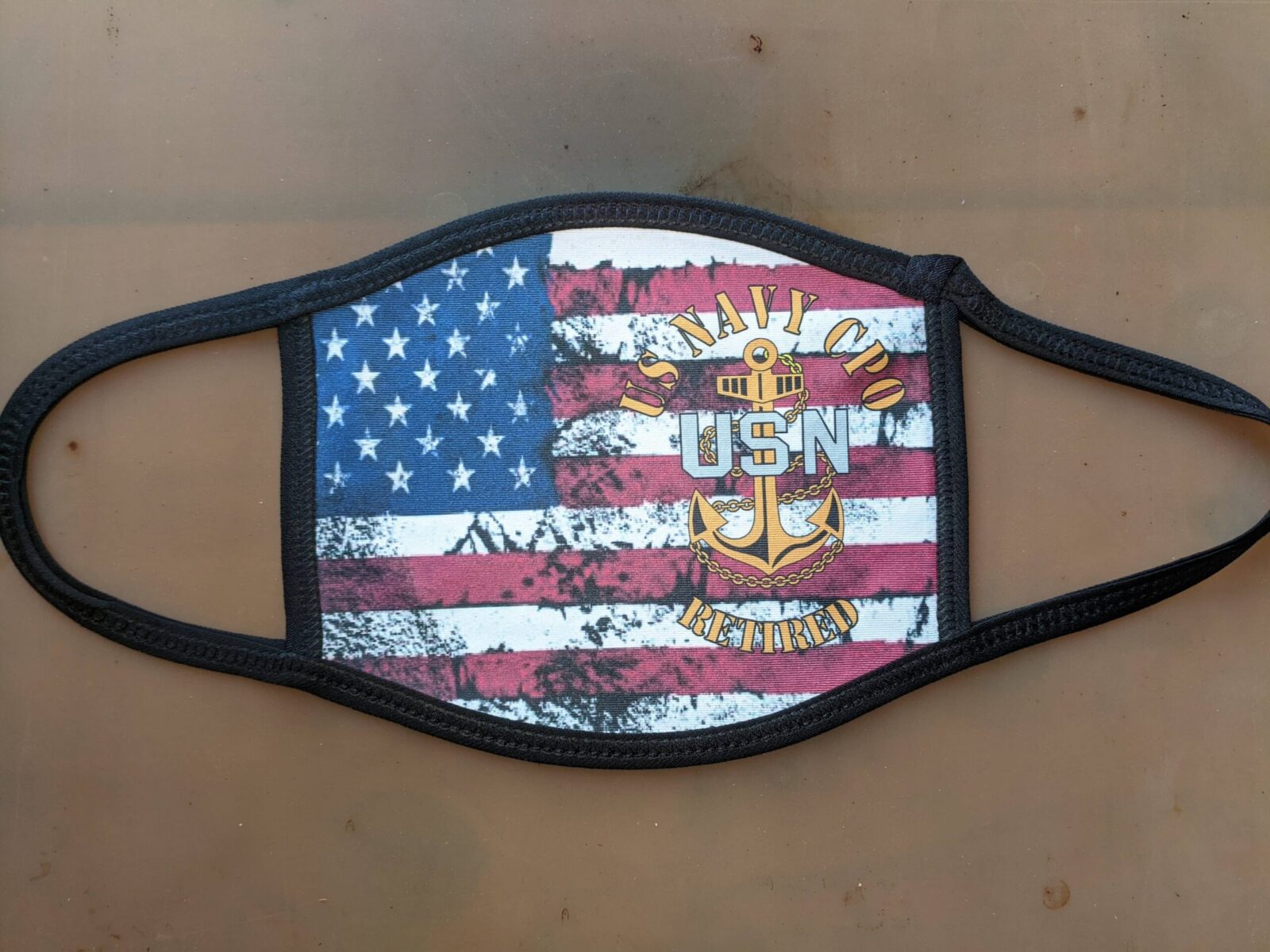 Cloth face mask featuring a US flag and "NAVY CHIEF USN RETIRED" emblem on the front. Product: Import placeholder 13481.
