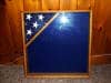 Import placeholder for 1000: Wooden display case with blue background, five white stars, leaning on a wooden wall.