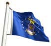 Import placeholder for 1154: Blue U.S. Air Force emblem flag with white stars, waving on a pole against a white background.