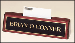 A nameplate labeled "Import placeholder for 1181" with a business card held in a slot behind it.