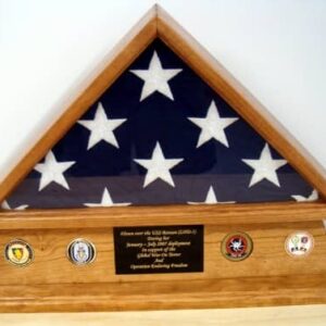Import placeholder for 1430: Folded American flag in a wooden case with 4 military medallions and a commemorative plaque.