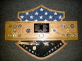 Import placeholder for 350 featuring medals, a folded American flag, and a central plaque on a gray surface.