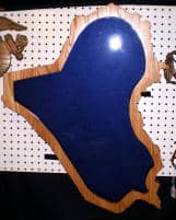 Import placeholder for 392 features a blue Iraq outline on wood, displayed on a pegboard.