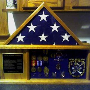 The Import placeholder for 699 is a wooden display case for a folded U.S. flag, medals, a plaque, and Navy emblem.
