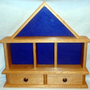 Import placeholder for 749: Triangular-top wooden shelf with blue back, 3 compartments, and 2 bottom drawers.